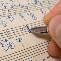 person-writing-on-sheet-music-200
